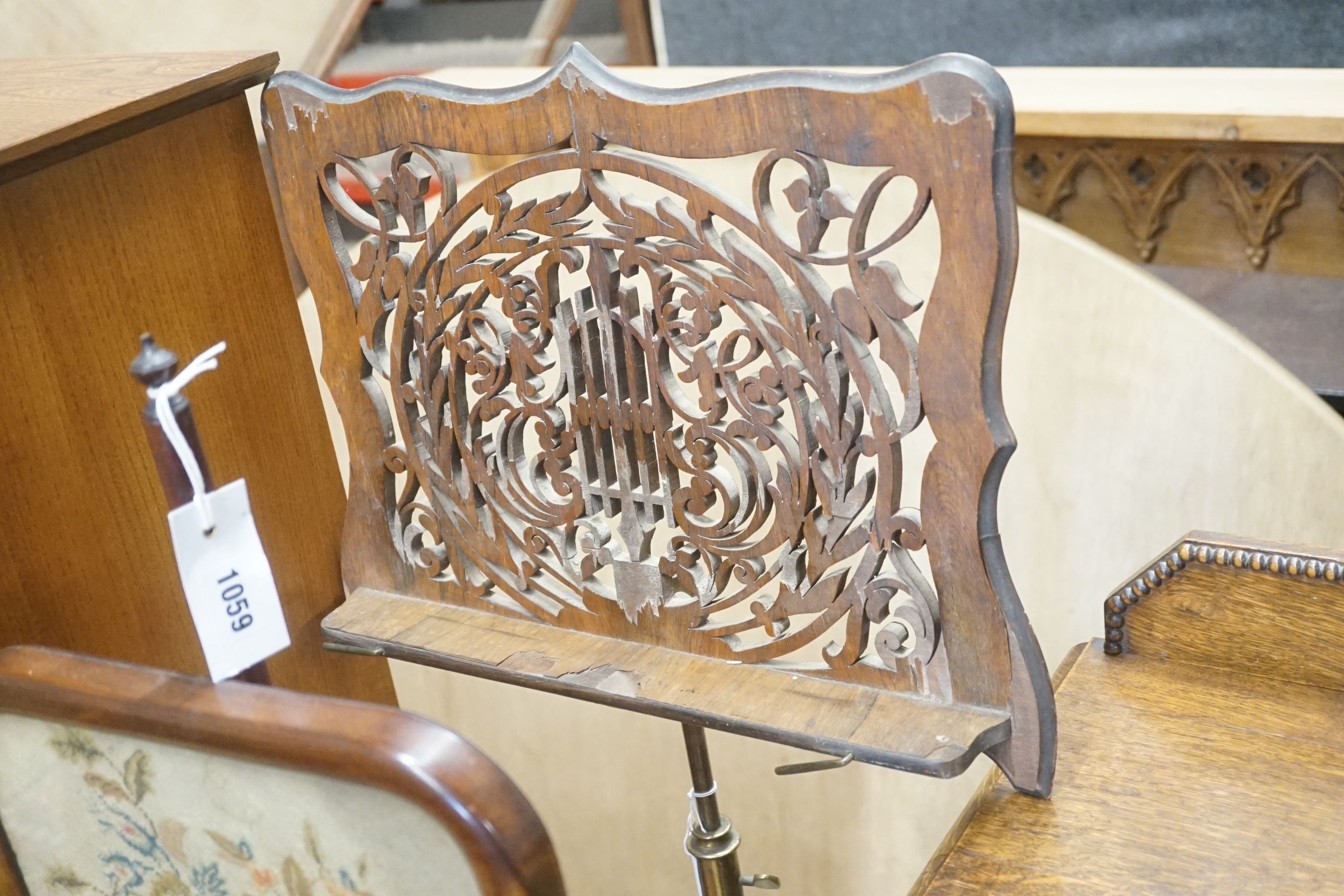 A Victorian rosewood pole screen and a fret cut music stand